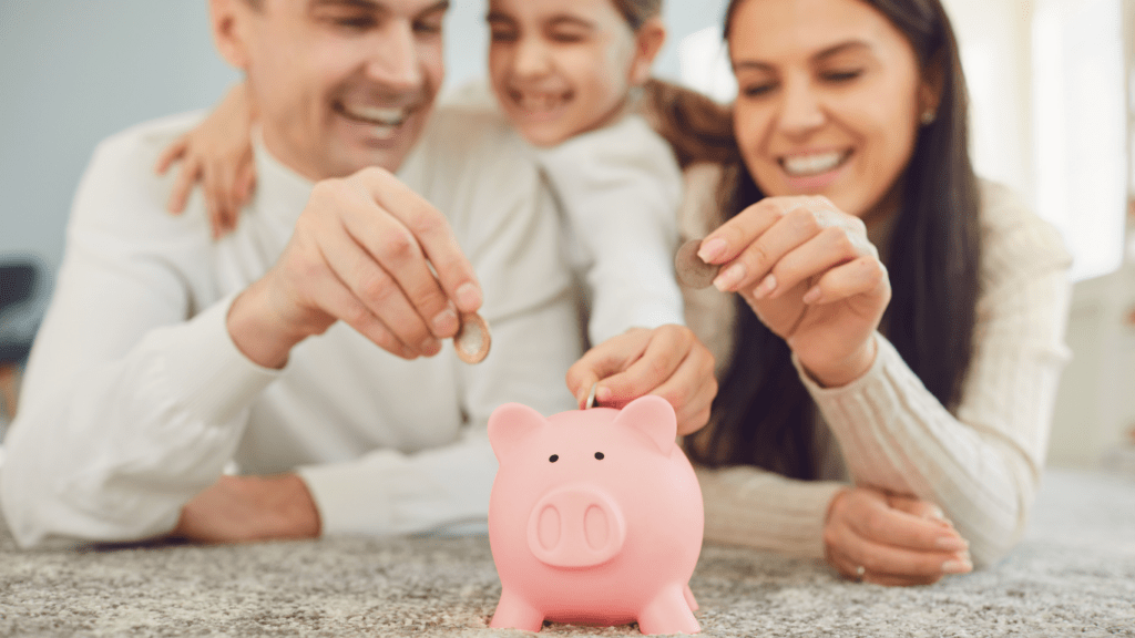 A family is putting money into a piggy bank