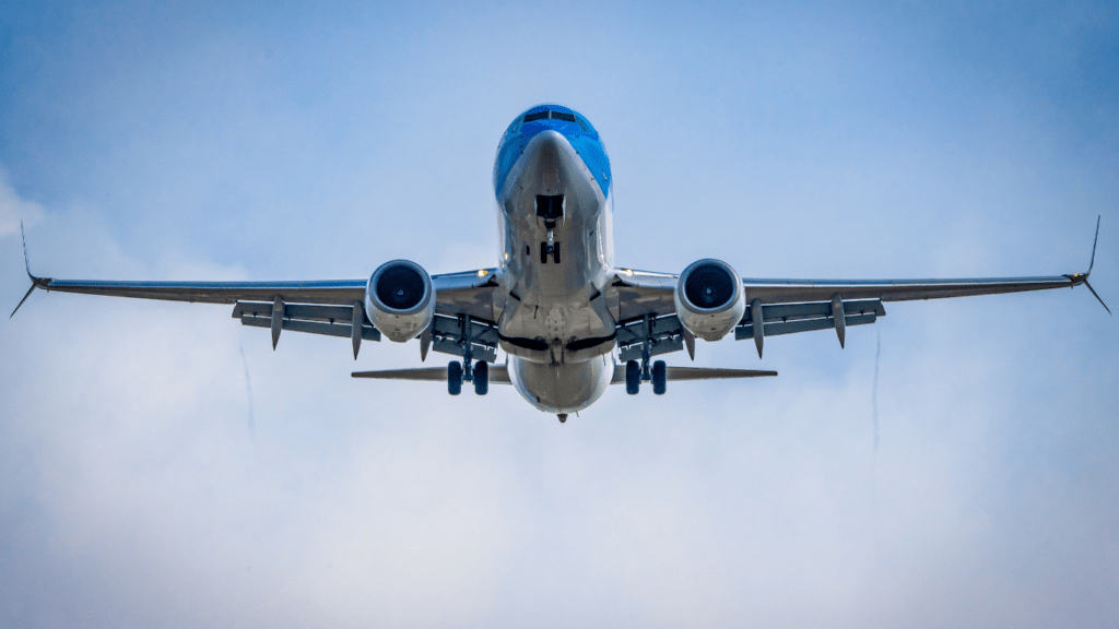 A large passenger jet flying through a blue sky