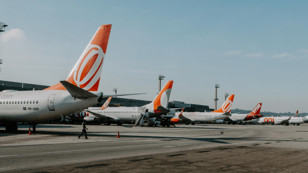 a row of private jets parked on an airport