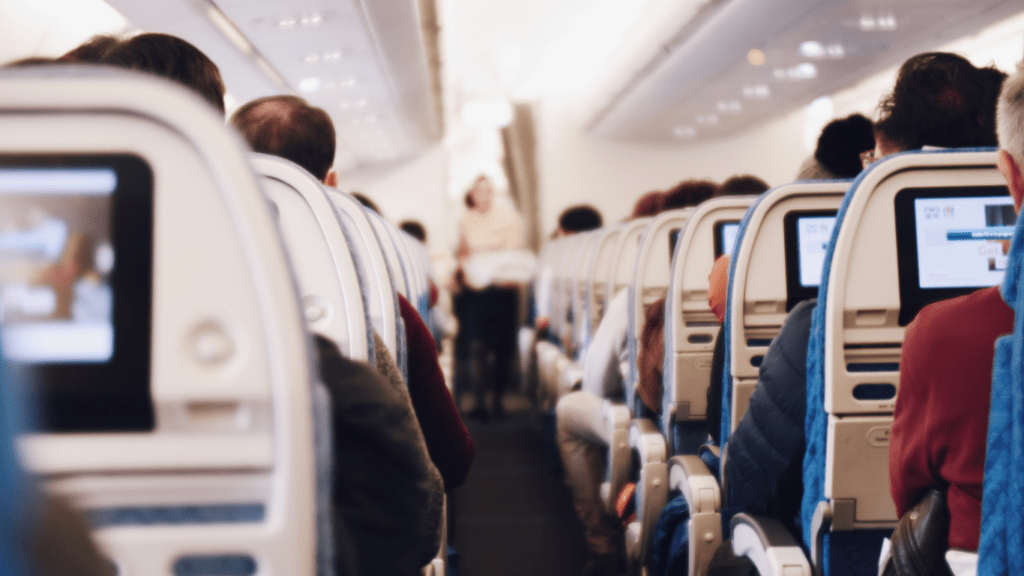 many people are sitting on the seats of an airplane