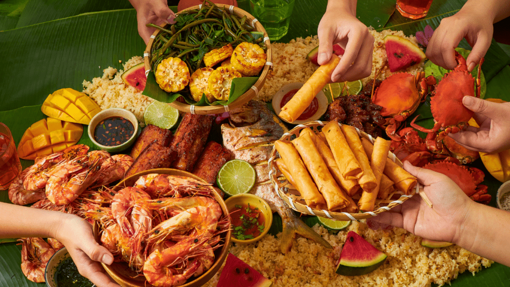 a group of people eating food on a banana leaf
