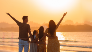 silhouette of a family on the beach at sunset