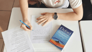 close up of a hand writing in a notebook