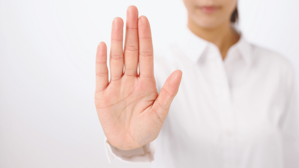a person with their hands up in front of their face