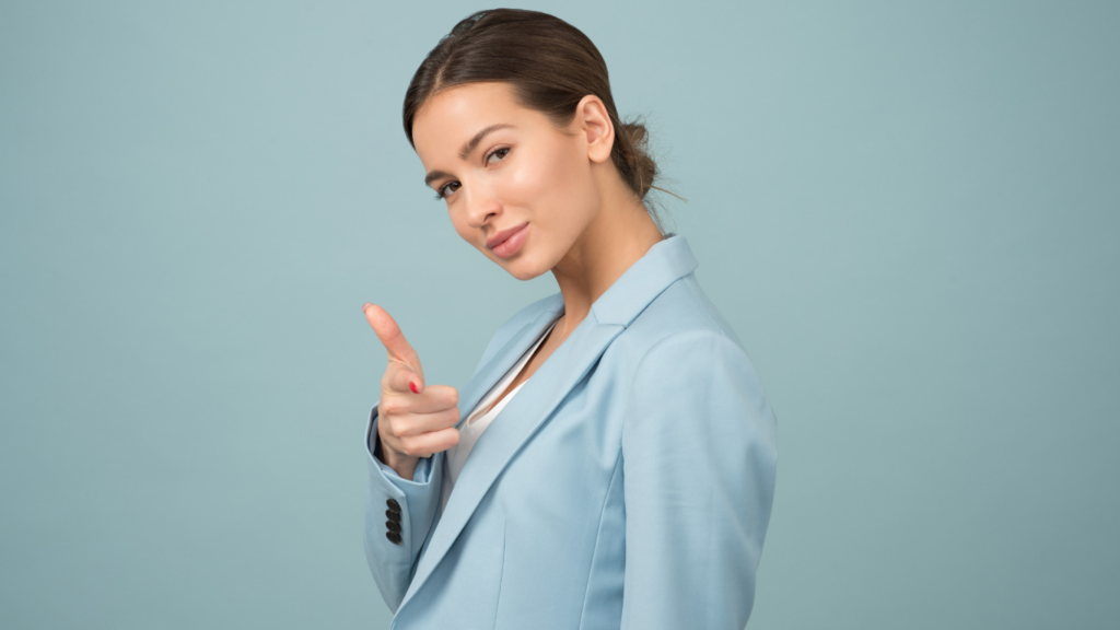 A woman standing wearing a blue suit