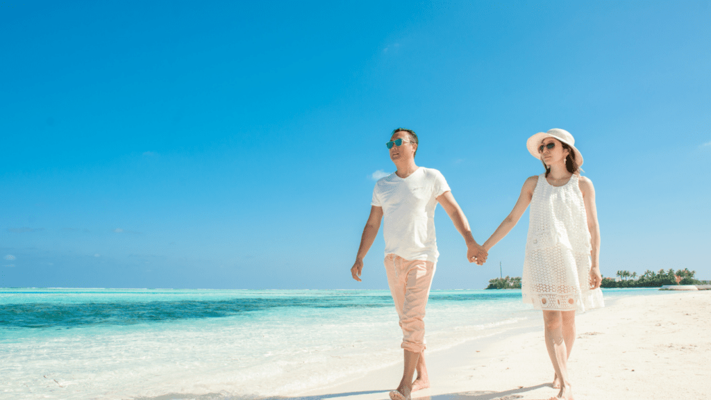Two people walking on the beach