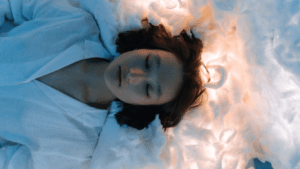 a person sleeping in a bed surrounded by clouds