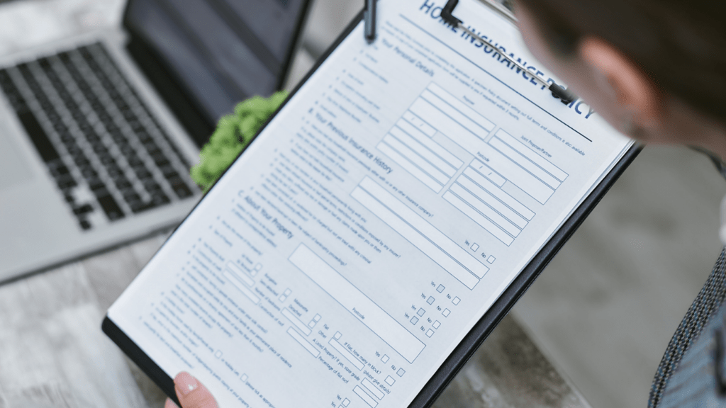 A person in a business suit is holding a clipboard