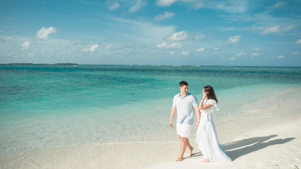 Two people walking on the beach