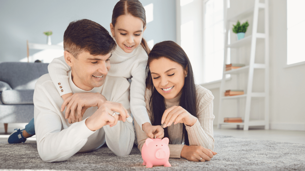 A family is putting money into a piggy bank