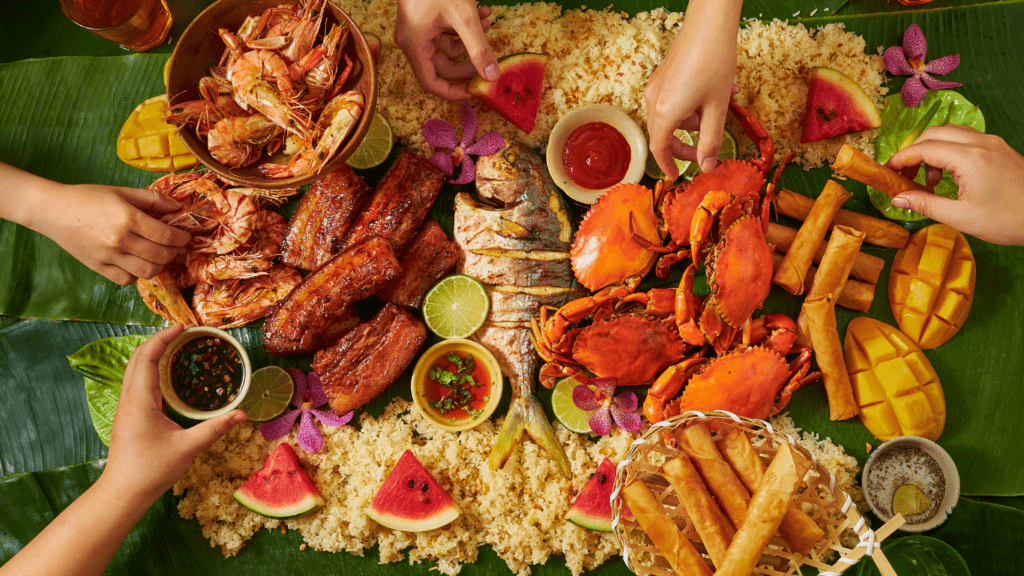 a group of people eating food on a banana leaf