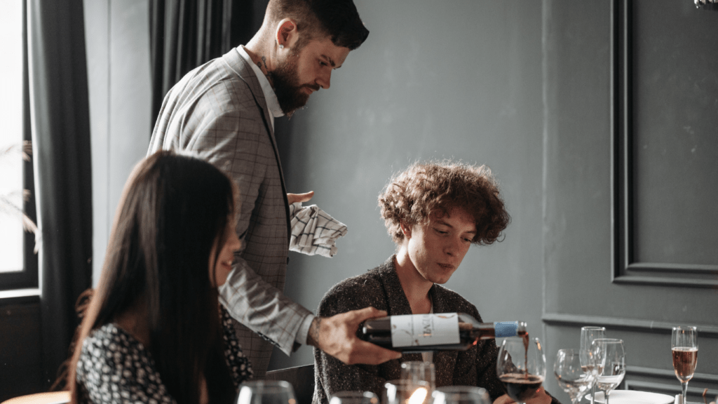 a group of people sitting at a table with wine glasses