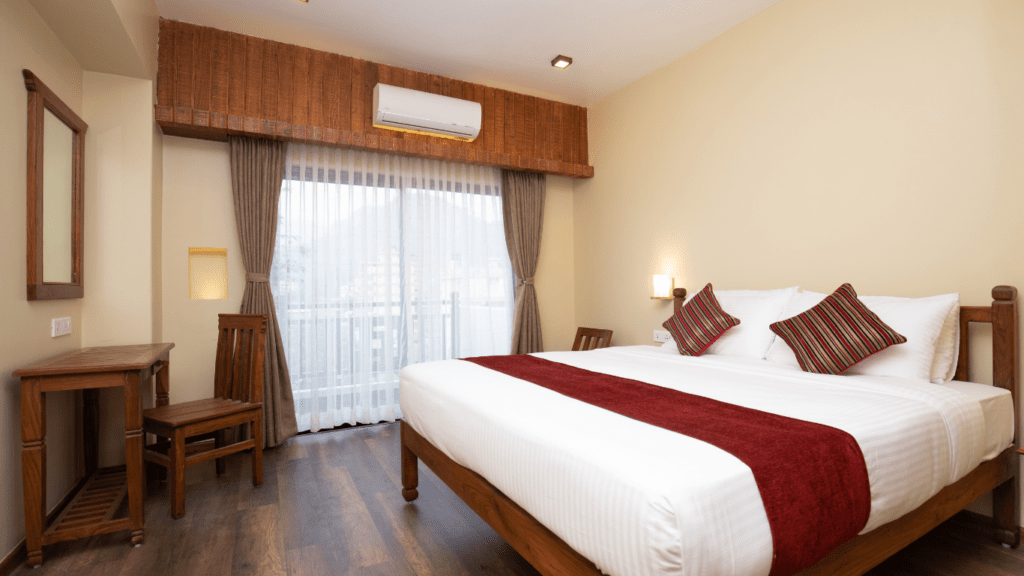 a hotel room with wooden floors and a large bed