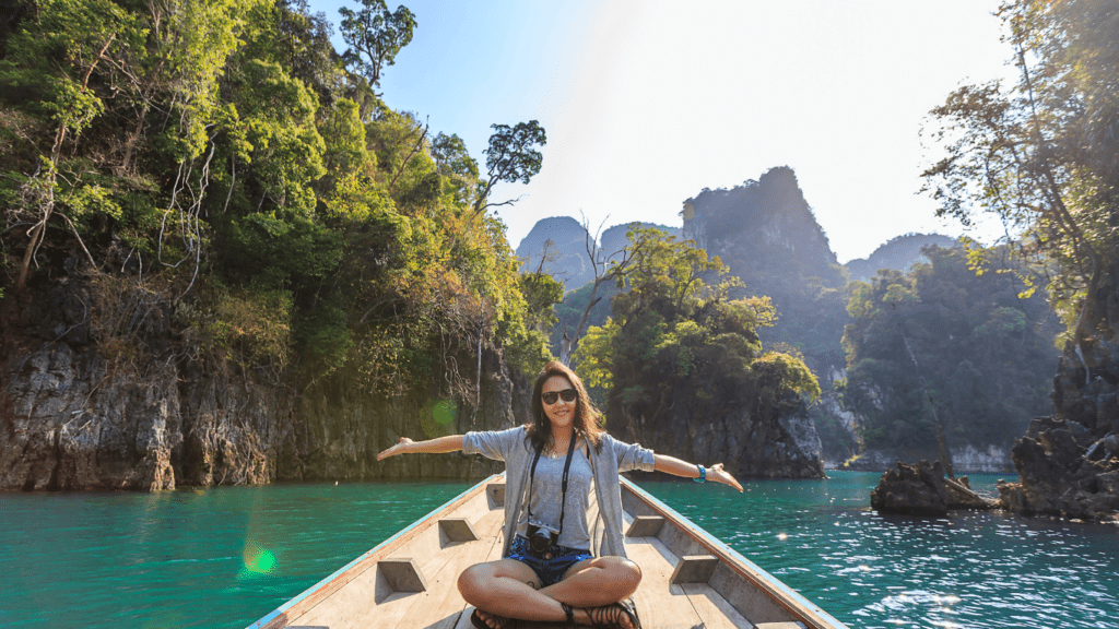 a person is sitting on a boat in the middle of a lake