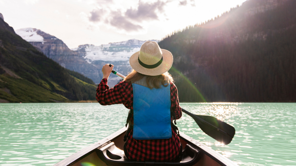 a person paddles a canoe
