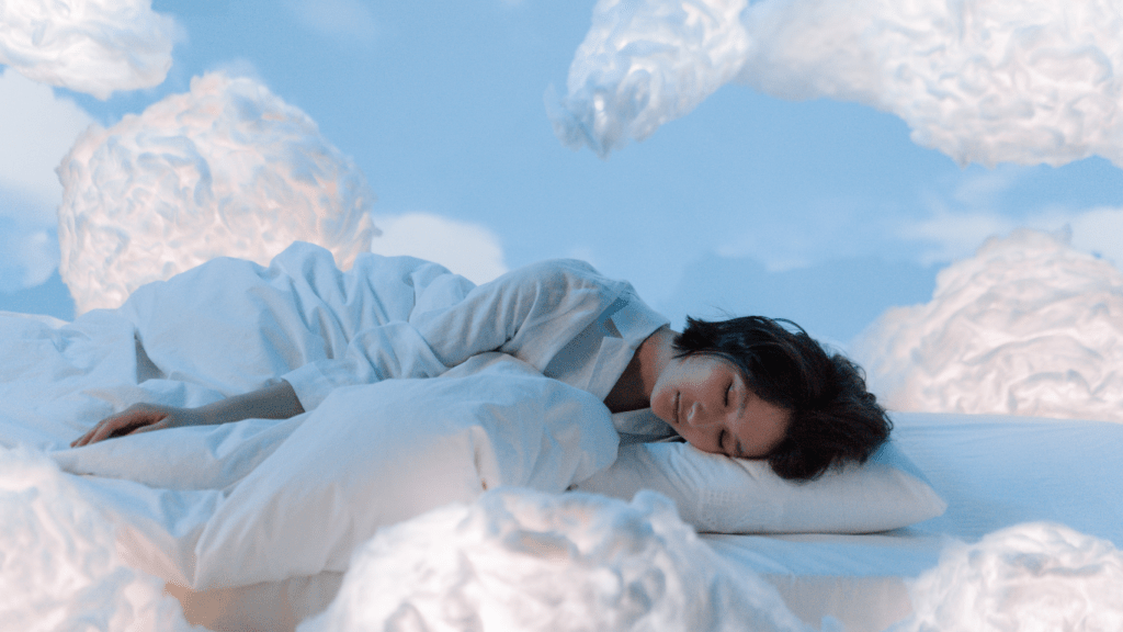 a person sleeping in a bed surrounded by clouds