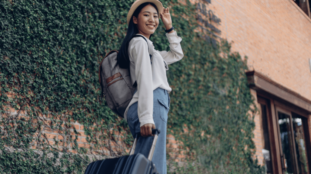 a person with a suitcase standing in front of a building