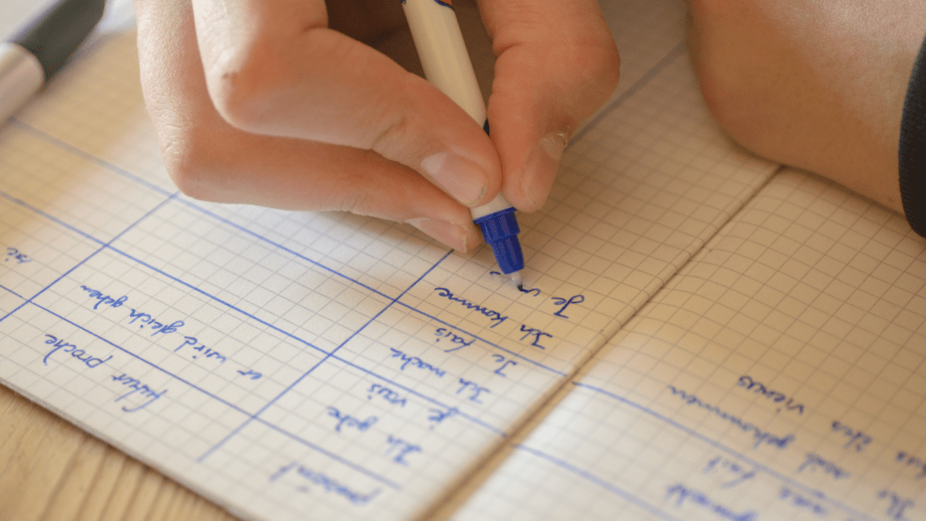 close up of a hand writing in a notebook