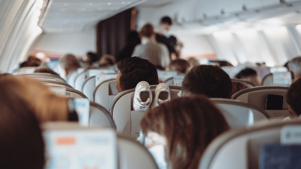 many people are sitting on the seats of an airplane